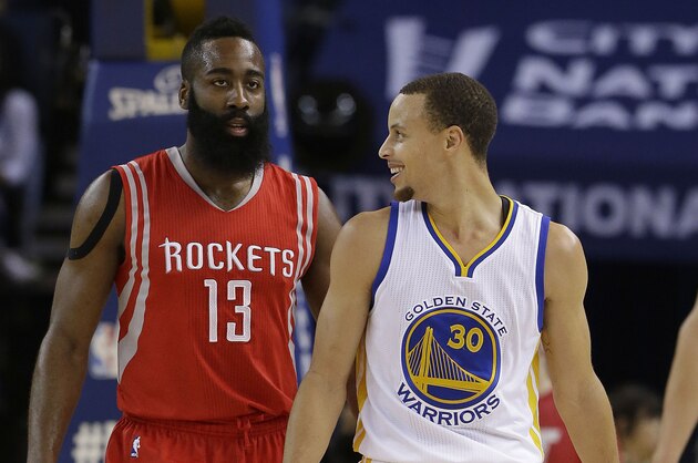 Golden State Warriors guard Stephen Curry (30) smiles next to Houston Rockets guard James Harden (13) during the first half of an NBA basketball game in Oakland, Calif., Wednesday, Jan. 21, 2015. (AP Photo/Jeff Chiu)