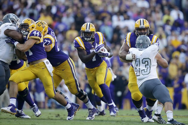 FILE - In this Oct. 3, 2015, file photo, LSU running back Leonard Fournette (7) carries past Eastern Michigan linebacker Anthony Zappone (43) in the first half of an NCAA college football game in Baton Rouge, La. The offensive linemen for seventh-ranked LSU try to block equally well on every play, no matter who has the ball. Yet they can't help but acknowledge there's just something especially rewarding about blocking for Heisman Trophy hopeful Leonard Fournette, and it shows.  (AP Photo/Gerald Herbert, File)
