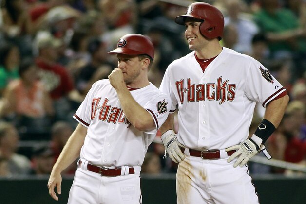 Arizona Diamondbacks' Paul Goldschmidt, right, and third base coach Andy Green share a laugh after Goldschmidt advance to third on a single by teammate David Peralta during the third inning of a baseball game against the Philadelphia Phillies, Monday, Aug. 10, 2015, in Phoenix. The Diamondbacks defeated the Phillies 13-3. (AP Photo/Ralph Freso)
