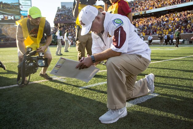 Sep 26, 2015; Minneapolis, MN, USA; Minnesota Golden Gophers head coach Jerry Kill kneels down after the game against the Ohio Bobcats at TCF Bank Stadium. The Gophers won 27-24. Mandatory Credit: Jesse Johnson-USA TODAY Sports
