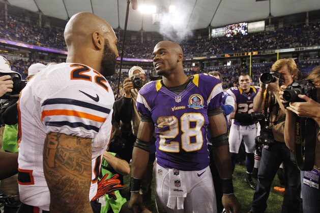 Minnesota Vikings running back Adrian Peterson (28) chats with Chicago Bears running back Matt Forte (22) at the end of an NFL football game Sunday, Dec. 9, 2012, in Minneapolis. The Vikings won 21-14. (AP Photo/Genevieve Ross)