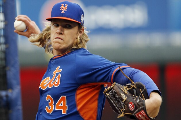 New York Mets pitcher Noah Syndergaard has the name Thor monogrammed on his glove as he throws at batting practice for the Major League Baseball World Series against the Kansas City Royals Monday, Oct. 26, 2015, in Kansas City, Mo. (AP Photo/Matt Slocum)