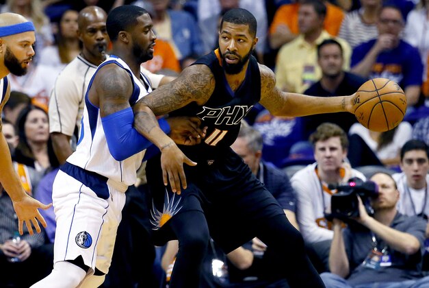 Dallas Mavericks' Wesley Matthews (23) defends against Phoenix Suns' Markieff Morris (11) during the first half of an NBA basketball game,  Wednesday, Oct. 28, 2015, in Phoenix. (AP Photo/Matt York)