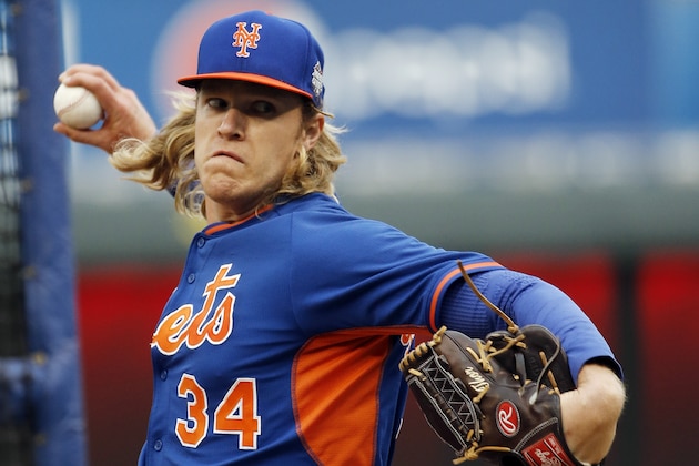 New York Mets pitcher Noah Syndergaard has the name Thor monogrammed on his glove as he throws at batting practice for the Major League Baseball World Series against the Kansas City Royals Monday, Oct. 26, 2015, in Kansas City, Mo. (AP Photo/Matt Slocum)