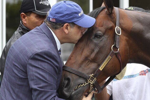 Kentucky Derby and Preakness Stakes winner American Pharoah, gets a kiss from his owner, Ahmed Zayat after a workout at Belmont Park, Friday, June 5, 2015, in Elmont, N.Y. American Pharoah will try for a Triple Crown when he runs in Saturday's 147th running of the Belmont Stakes horse race. (AP Photo/Peter Morgan)