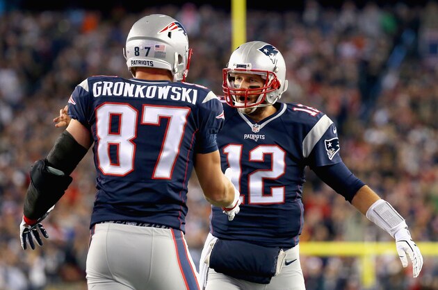 FOXBORO, MA - OCTOBER 29:  Rob Gronkowski #87 and Tom Brady #12 of the New England Patriots react after Gronkowski scored a touchdown during the first quarter against the Miami Dolphins at Gillette Stadium on October 29, 2015 in Foxboro, Massachusetts.  (Photo by Jim Rogash/Getty Images)