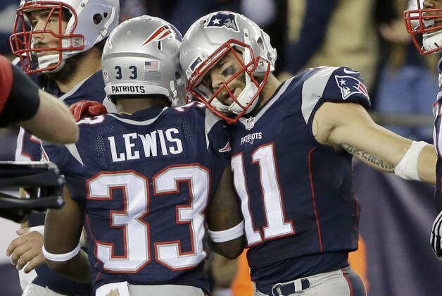 New England Patriots running back Dion Lewis (33) congratulates wide receiver Julian Edelman (11) on his touchdown in the second half of an NFL football game against the Miami Dolphins, Thursday, Oct. 29, 2015, in Foxborough, Mass. (AP Photo/Steven Senne)