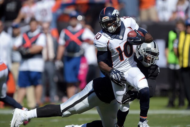 Oct 11, 2015; Oakland, CA, USA; Denver Broncos receiver Emmanuel Sanders (10) is tackled by Oakland Raiders linebacker Khalil Mack (52) at O.co Coliseum. Mandatory Credit: Kirby Lee-USA TODAY Sports
