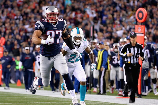 FOXBORO, MA - OCTOBER 29:  Rob Gronkowski #87 of the New England Patriots carries the ball as he scores a touchdown during the first quarter against the Miami Dolphins at Gillette Stadium on October 29, 2015 in Foxboro, Massachusetts.  (Photo by Jim Rogash/Getty Images)