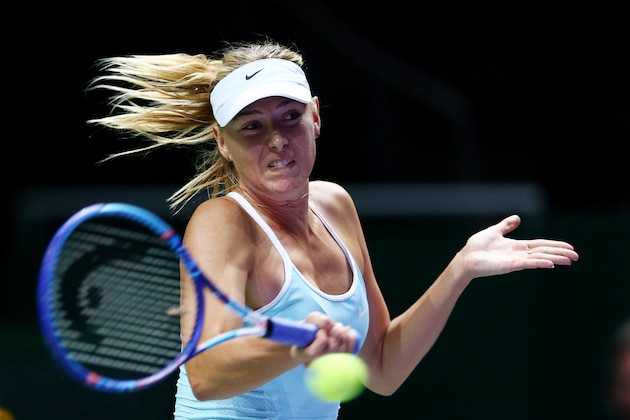 SINGAPORE - OCTOBER 29:  Maria Sharapova of Russia in action against Flavia Pennetta of Italy in a round robin match during the BNP Paribas WTA Finals at Singapore Sports Hub on October 29, 2015 in Singapore.  (Photo by Clive Brunskill/Getty Images)