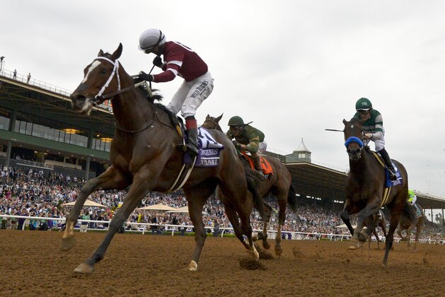 Rosie Napravnik, left, rides Untapable to victory past Joseph Rocco, Jr. on Don't Tell Sophia, and Joseph Talamo on Iotapa, right, in the Breeders' Cup Distaff horse race at Santa Anita on Friday, Oct. 31, 2014, in Arcadia, Calif. (AP Photo/Mark J. Terrill)