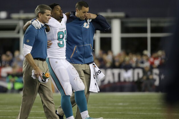 Miami Dolphins defensive end Cameron Wake is helped off the field after an injury in the second half of an NFL football game against the New England Patriots, Thursday, Oct. 29, 2015, in Foxborough, Mass. (AP Photo/Steven Senne)