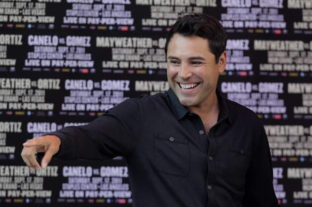 Boxing promoter and former boxing champion Oscar De La Hoya points toward the crowd during a media event for Floyd Mayweather Jr. and Victor Ortiz at CityWalk  in Universal City, Calif., Monday, Sept. 12, 2011. Mayweather Jr. and Ortiz will fight in a WBC welterweight title match, Saturday in Las Vegas. (AP Photo/Jae C. Hong)
