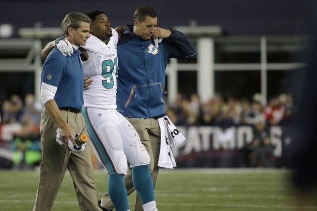 Miami Dolphins defensive end Cameron Wake is helped off the field after an injury in the second half of an NFL football game against the New England Patriots, Thursday, Oct. 29, 2015, in Foxborough, Mass. (AP Photo/Steven Senne)