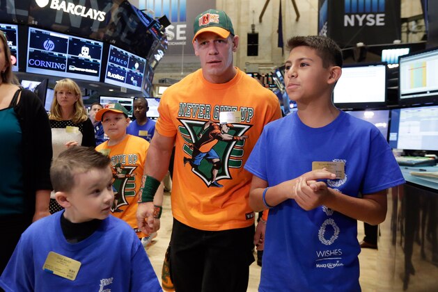 World Wrestling Entertainment superstar John Cena, center, is accompanied by Make-A-Wish participants Evan Maher, and Elijah Mendoza, foreground left and right, as he visits the trading floor, Friday, Aug. 21, 2015, before ringing the New York Stock Exchange opening bell. To date, WWE superstars and divas have granted more than 6,000 wishes. This was Cena's 500th granted wish. (AP Photo/Richard Drew) World Wrestling Entertainment superstar John Cena, center, is accompanied by Make-A-Wish participants Evan Maher, and Elijah Mendoza, foreground left and right, as he visits the trading floor, Friday, Aug. 21, 2015, before ringing the New York Stock Exchange opening bell. To date, WWE superstars and divas have granted more than 6,000 wishes. This was Cena's 500th granted wish. (AP Photo/Richard Drew)
