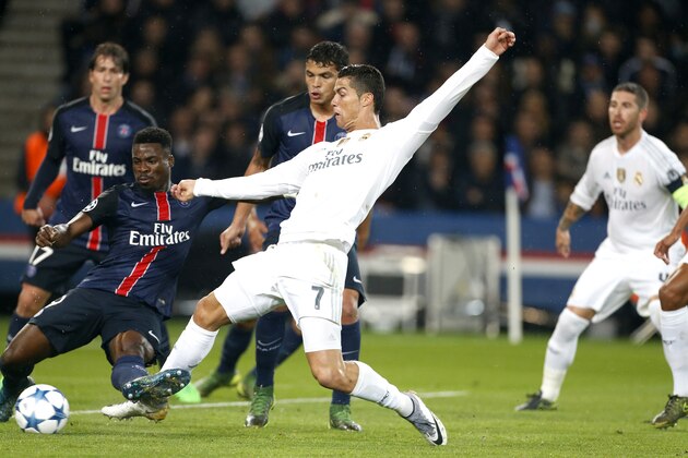 PARIS, FRANCE - OCTOBER 21: Cristiano Ronaldo of Real Madrid and Serge Aurier of PSG (left) in action during the UEFA Champions League match between Paris Saint-Germain (PSG) and Real Madrid at Parc des Princes stadium on October 21, 2015 in Paris, France. (Photo by Jean Catuffe/Getty Images)