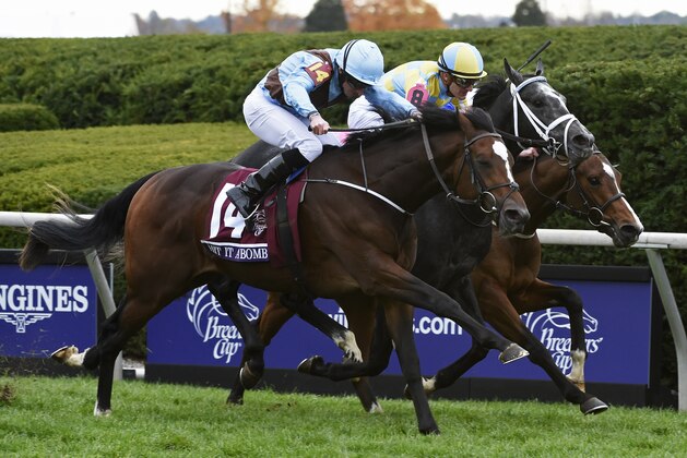 Oct 30, 2015; Lexington, KY, USA;  Ryan More aboard Hit It a Bomb races alongside Julien Leparoux aboard Airoforce and James Doyle aboard Birchwood in race six of the 2015 Breeders Cup Championships at Keeneland. Mandatory Credit: Richard Mackson-USA TODAY Sports