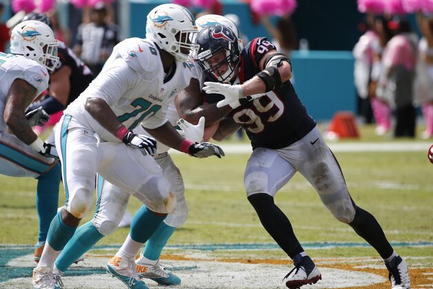 Houston Texans defensive end J.J. Watt (99) defends against Miami Dolphins tackle Ja'Wuan James (70) during the first half of an NFL football game against the Miami Dolphins, Sunday, Oct. 25, 2015 in Miami Gardens, Fla. (AP Photo/Wilfredo Lee)
