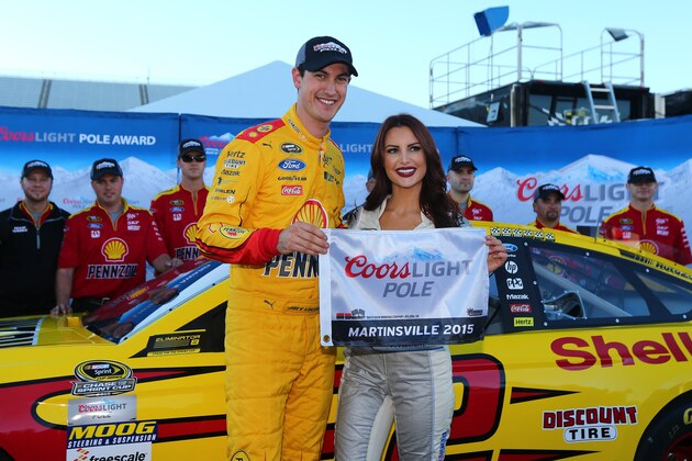 MARTINSVILLE, VA - OCTOBER 30:  Joey Logano, driver of the #22 Shell Pennzoil Ford, poses with Miss Coors Light Amanda Mertz and the Coors Light Pole award after qualifying for pole position for for the NASCAR Sprint Cup Series Goody's Headache Relief Shot 500 at Martinsville Speedway on October 30, 2015 in Martinsville, Virginia.  (Photo by Sarah Crabill/Getty Images)