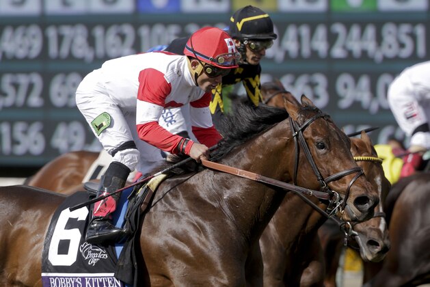 Jockey Joel Rosario rides Bobby's Kitten to a win in the Breeders' Cup Turf Sprint horse race at Santa Anita Park, Saturday, Nov. 1, 2014, in Arcadia, Calif.