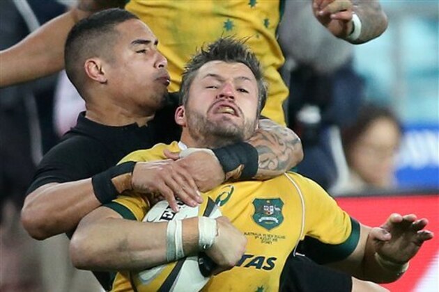 Australia's Adam Ashley-Cooper, right, is taken high by New Zealand's Aaron Smith during their Rugby Championship match in Sydney, Australia, Saturday, Aug. 8, 2015. (AP Photo/Rick Rycroft)