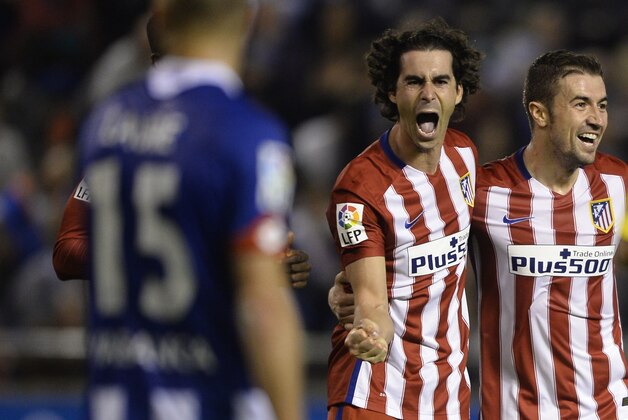 Atletico Madrid's Portuguese midfielder Tiago (C) celebrates with teammate midfielder Gabi after scoring a goal during the Spanish league football match RC Deportivo La Coruna vs Club Atletico de Madrid at the Municipal de Riazor stadium in La Coruna on October 30, 2015.  AFP PHOTO / MIGUEL RIOPA        (Photo credit should read MIGUEL RIOPA/AFP/Getty Images)