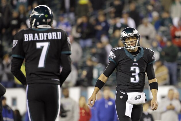Philadelphia Eagles quarterbacks Sam Bradford, left, and Mark Sanchez warm up prior to an NFL football game against the New York Giants, Monday, Oct. 19, 2015, in Philadelphia. (AP Photo/Michael Perez)