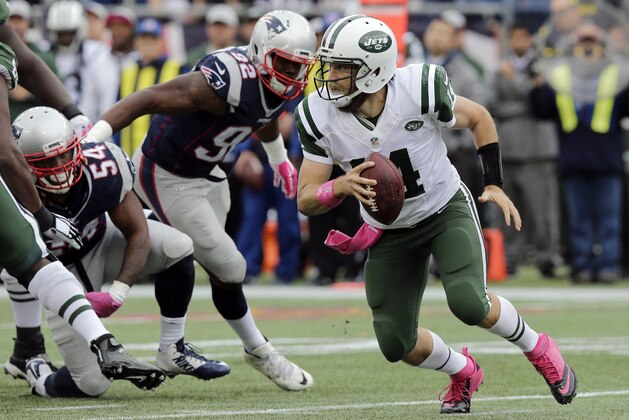 New York Jets quarterback Ryan Fitzpatrick (14) scrambles away from New England Patriots linebackers Dont'a Hightower (54) and Geneo Grissom (92) during the first half of an NFL football game, Sunday, Oct. 25, 2015, in Foxborough, Mass. (AP Photo/Charles Krupa)