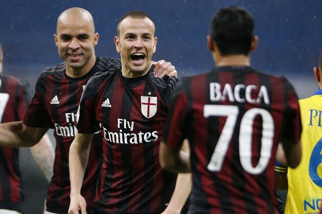 AC Milan’s Luca Antonelli, center, celebrates with his teammates Alex, left, and Carlos Bacca after scoring during the Serie A soccer match between AC Milan and Chievo at the San Siro stadium in Milan, Italy, Wednesday, Oct. 28, 2015. (AP Photo/Antonio Calanni)