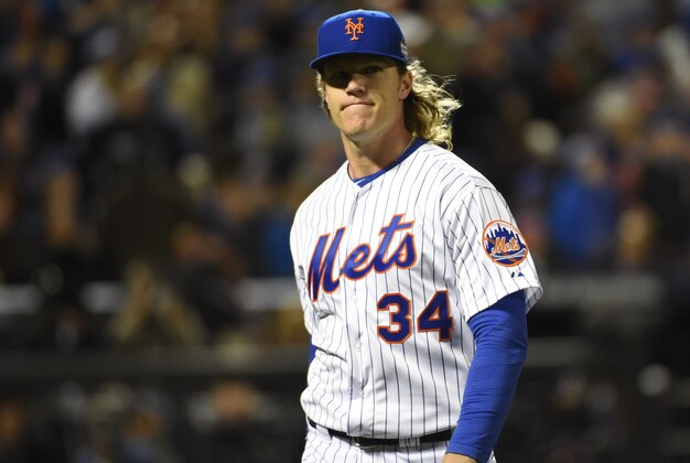 Oct 30, 2015; New York City, NY, USA; New York Mets starting pitcher Noah Syndergaard (34) reacts after retiring the Kansas City Royals in the first inning in game three of the World Series at Citi Field. Mandatory Credit: Robert Deutsch-USA TODAY Sports