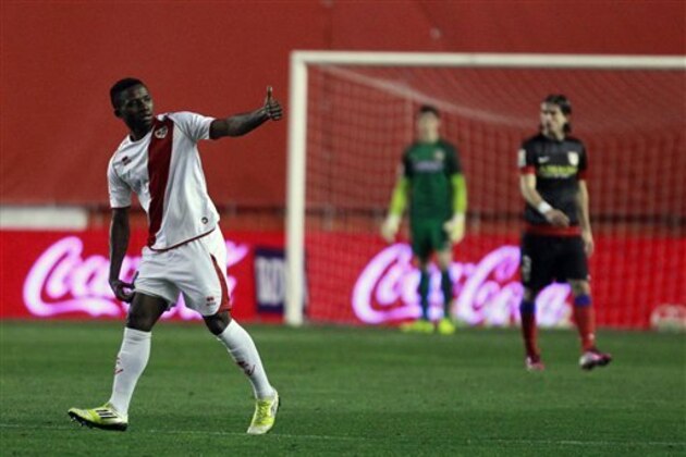 Rayo Vallecano's Lass Bangoura, left, celebrates his goal during a Spanish La Liga soccer match against Atletico Madrid at the Vallecas stadium in Madrid, Spain, Sunday, Feb. 10, 2013. (AP Photo/Andres Kudacki)