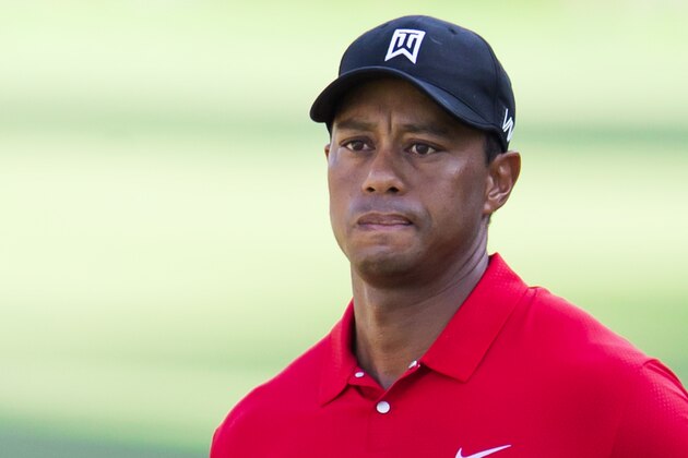 Tiger Woods watches a chip shot to the 15th green during the final round of the Wyndham Championship golf tournament at Sedgefield Country Club in Greensboro, N.C., Sunday, Aug. 23, 2015. (AP Photo/Rob Brown)