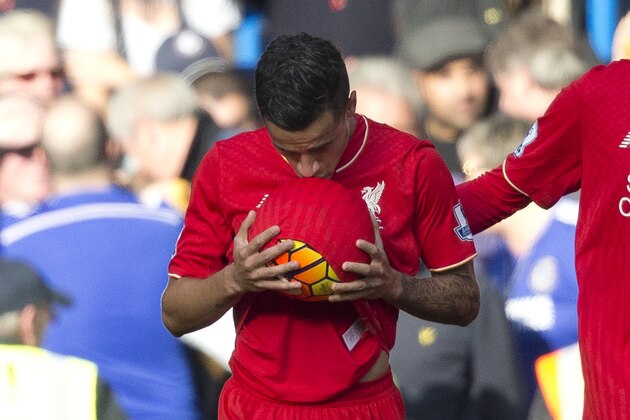 Liverpool's Philippe Coutinho kisses the ball after scoring his side's first goal during the English Premier League soccer match between Chelsea and Liverpool at Stamford Bridge stadium in London, Saturday, Oct. 31, 2015.  (AP Photo/Matt Dunham)
