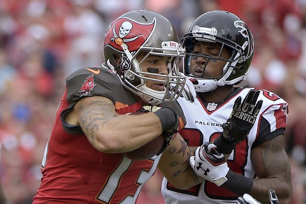 Tampa Bay Buccaneers wide receiver Mike Evans (13) is stopped by Atlanta Falcons cornerback Robert Alford (23) after a reception during the fourth quarter of an NFL football game Sunday, Nov. 9, 2014, in Tampa, Fla. (AP Photo/Phelan M. Ebenhack)