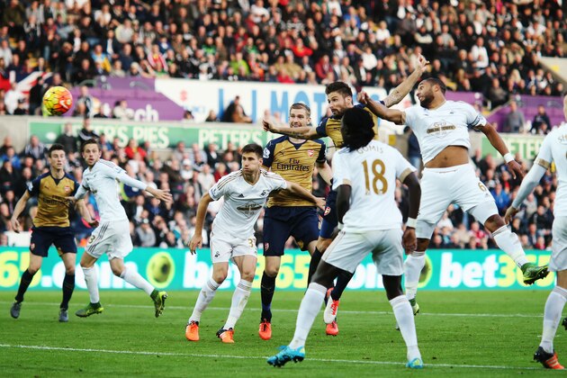 SWANSEA, WALES - OCTOBER 31: Olivier Giroud of Arsenal scores the opening goal during the Barclays Premier League match between Swansea City and Arsenal at Liberty Stadium on October 31, 2015 in Swansea, Wales.  (Photo by Ben Hoskins/Getty Images)