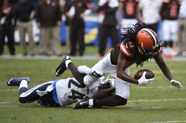 Cleveland Browns wide receiver Travis Benjamin is brought down by San Diego Chargers cornerback Brandon Flowers during the first half in an NFL football game Sunday, Oct. 4, 2015, in San Diego. (AP Photo/Denis Poroy)