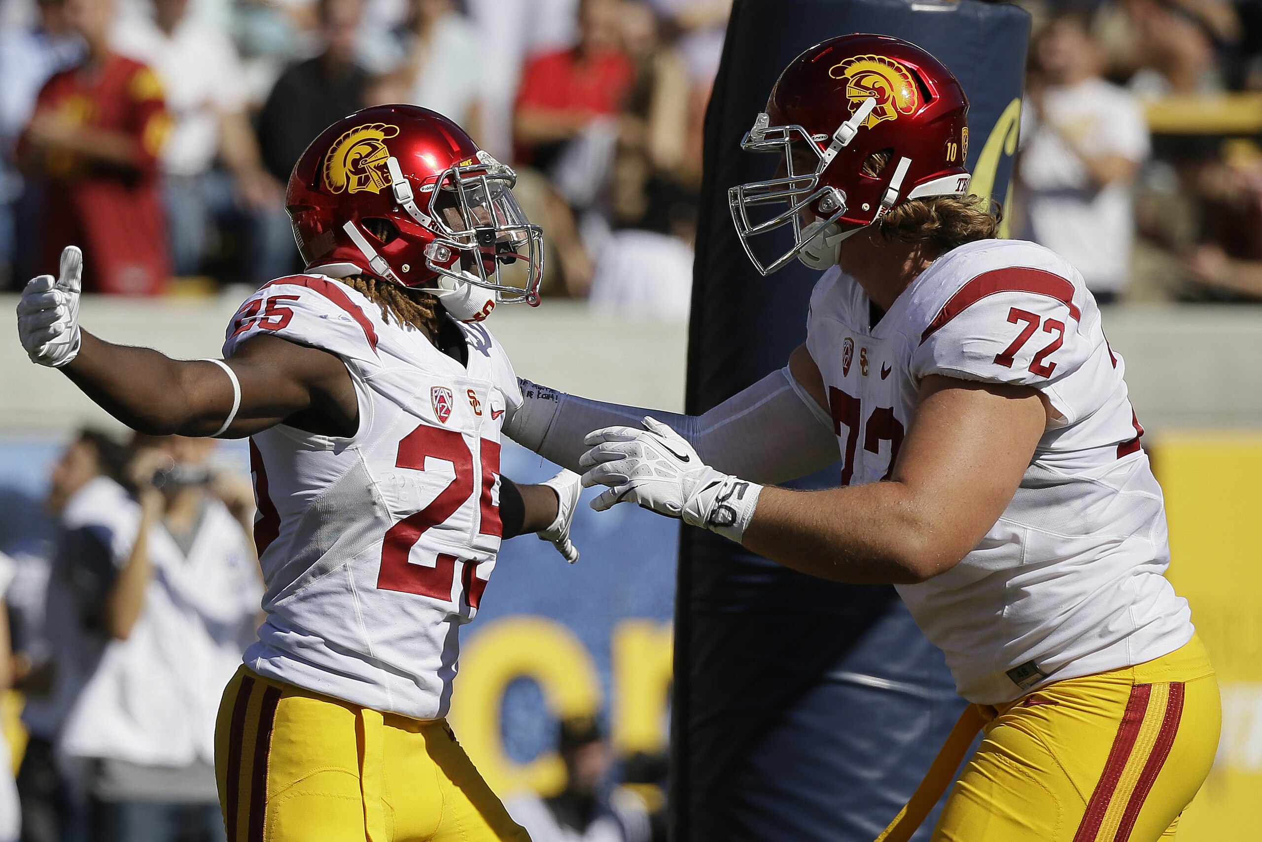 Southern California running back Ronald Jones II, left, is greeted by teammate Chad Wheeler, right, after scoring a touchdown during the first half of an NCAA college football game against California, Saturday, Oct. 31, 2015, in Berkeley, Calif. (AP Photo/Eric Risberg) Southern California running back Ronald Jones II, left, is greeted by teammate Chad Wheeler, right, after scoring a touchdown during the first half of an NCAA college football game against California, Saturday, Oct. 31, 2015, in Berkeley, Calif. (AP Photo/Eric Risberg)