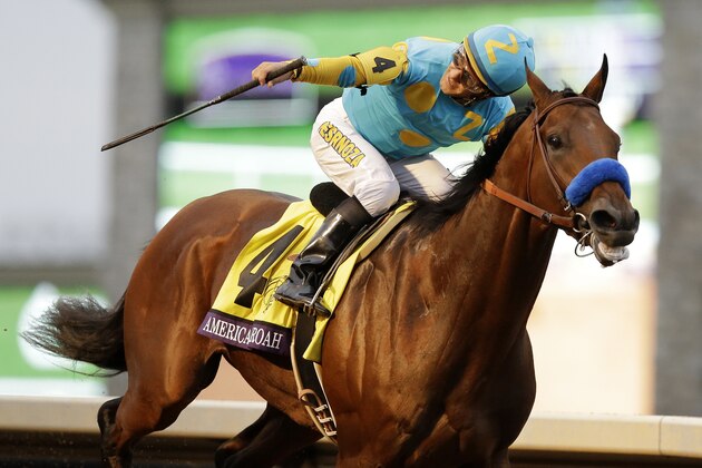 American Pharoah, with Victor Espinoza up, wins the Breeders' Cup Classic horse race at Keeneland race track Saturday, Oct. 31, 2015, in Lexington, Ky. (AP Photo/Mark Humphrey)