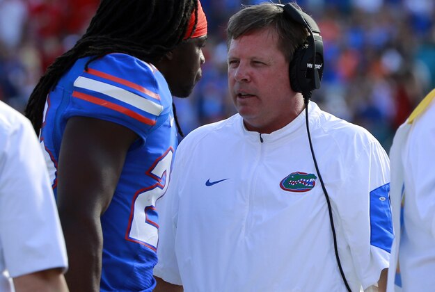 Oct 31, 2015; Jacksonville, FL, USA; Florida Gators head coach Jim McElwain talks with defensive back Marcell Harris (26) against the Georgia Bulldogs during the first quarter at  EverBank Stadium. Mandatory Credit: Kim Klement-USA TODAY Sports