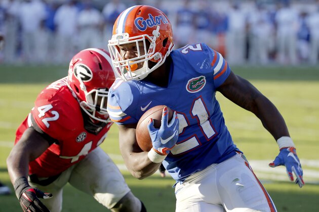 Florida running back Kelvin Taylor runs past Georgia linebacker Tim Kimbrough to the end zone for a touch down during the first half of an NCAA college football game, Saturday, Oct. 31, 2015, in Jacksonville, Fla. (AP Photo/Stephen B. Morton)