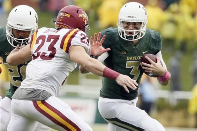 FILE - In this Oct. 24, 2015, file photo, Iowa State defensive back Darian Cotton (23) chases down Baylor quarterback Jarrett Stidham (3) on a running play during the second half of an NCAA college football game in Waco, Texas.  From Heisman Trophy winner Robert Griffin III to record-setting Nick Florence to two-time Big 12 champion Bryce Petty and Seth Russell, Baylor quarterbacks have thrived in coach Art Briles' big-play system. Next up is freshman Jarrett Stidham, whose turn for the No. 2 Bears comes much sooner than expected.  (AP Photo/Tony Gutierrez, File_