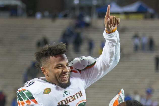 Miami's Corn Elder celebrates with teammate Tyriq McCord after he scored on a kickoff return to beat Duke 30-27 in an NCAA college football game, in Durham, N.C., Saturday, Oct. 31, 2015. (AP Photo/Rob Brown)