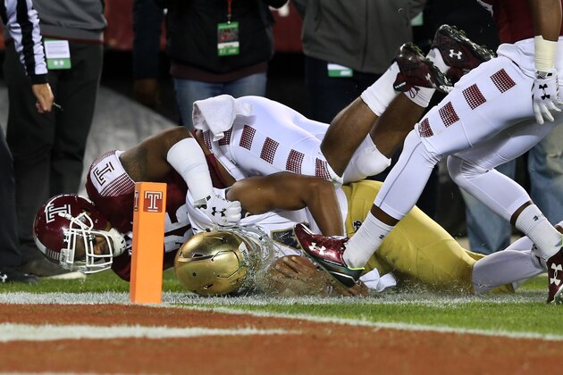 Temple defensive lineman Nate D. Smith (35) tackles Notre Dame quarterback DeShone Kizer (14) near the goal line during the first half of an NCAA college football game Saturday, Oct. 31, 2015, in Philadelphia. (AP Photo/Mel Evans)