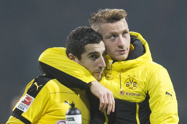 Dortmund's Marco Reus, right, hugs teammate Henrikh Mkhitaryan after the German Bundesliga soccer match between Werder Bremen and Borussia Dortmund in Bremen, Germany, Saturday, Oct. 31, 2015. (AP Photo/Joerg Sarbach)