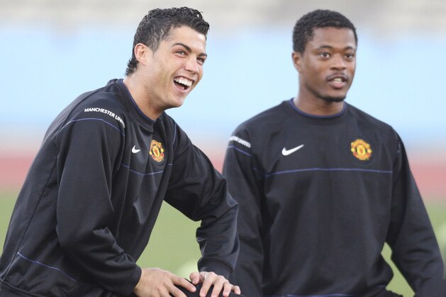 Cristiano Ronaldo of England's Manchester United, left,  and teammate Patrice Evra , right, stretch during a training for the final match of the FIFA Club World Cup Soccer tournament  in Kawasaki near Tokyo, Saturday, Dec. 20, 2008.  The European champions will play South American champions Liga de Quito in Sunday's final.  (AP Photo/Koji Sasahara)