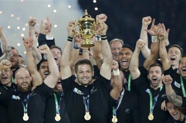 New Zealand's captain Richie McCaw holds the trophy aloft after the Rugby World Cup final between New Zealand and Australia at Twickenham Stadium in London,  Saturday, Oct. 31, 2015.  The All Blacks won 34-17. (AP Photo/Christophe Ena)
