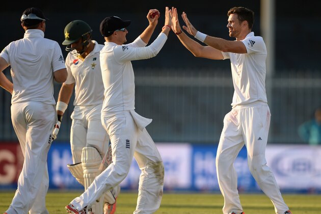 SHARJAH, UNITED ARAB EMIRATES - NOVEMBER 01:  James Anderson of England celebrates with Joe Root after dismissing Pakistan captain Misbah-ul-Haq during day one of the 3rd Test between Pakistan and England at Sharjah Cricket Stadium on November 1, 2015 in Sharjah, United Arab Emirates.  (Photo by Gareth Copley/Getty Images)