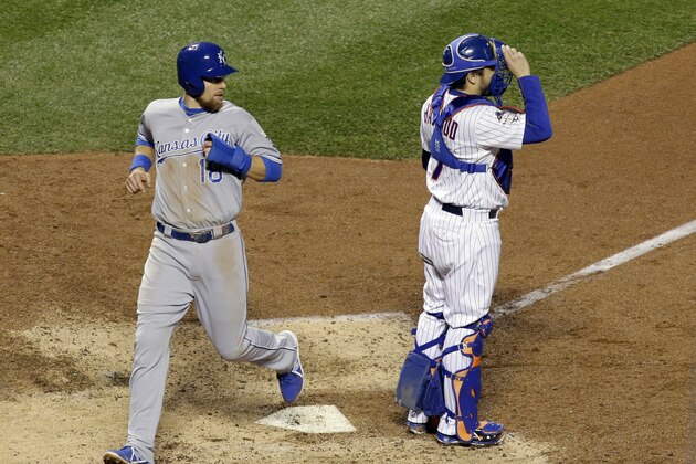 Kansas City Royals' Ben Zobrist, left, scores past New York Mets catcher Travis d'Arnaud on a fielding error by second baseman Daniel Murphy during the eighth inning of Game 4 of the Major League Baseball World Series Saturday, Oct. 31, 2015, in New York. (AP Photo/David J. Phillip)