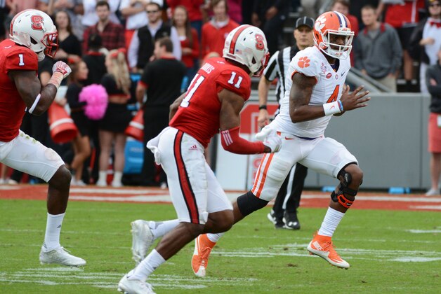 Oct 31, 2015; Raleigh, NC, USA; Clemson Tigers quarterback Deshaun Watson (4) runs during the first half as North Carolina State Wolfpack cornerback Justin Burris (11) pursues at Carter Finley Stadium. Mandatory Credit: Rob Kinnan-USA TODAY Sports