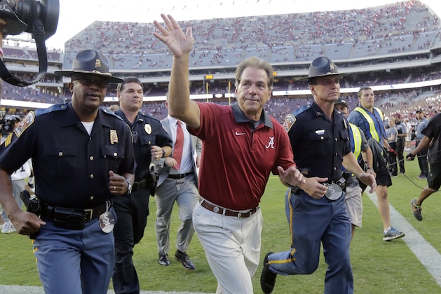 Alabama head coach Nick Saban waves to fans as he runs off the field following an NCAA college football game against Texas A&M, Saturday, Oct. 17, 2015, in College Station, Texas. Alabama won 41-23. (AP Photo/Eric Gay)
